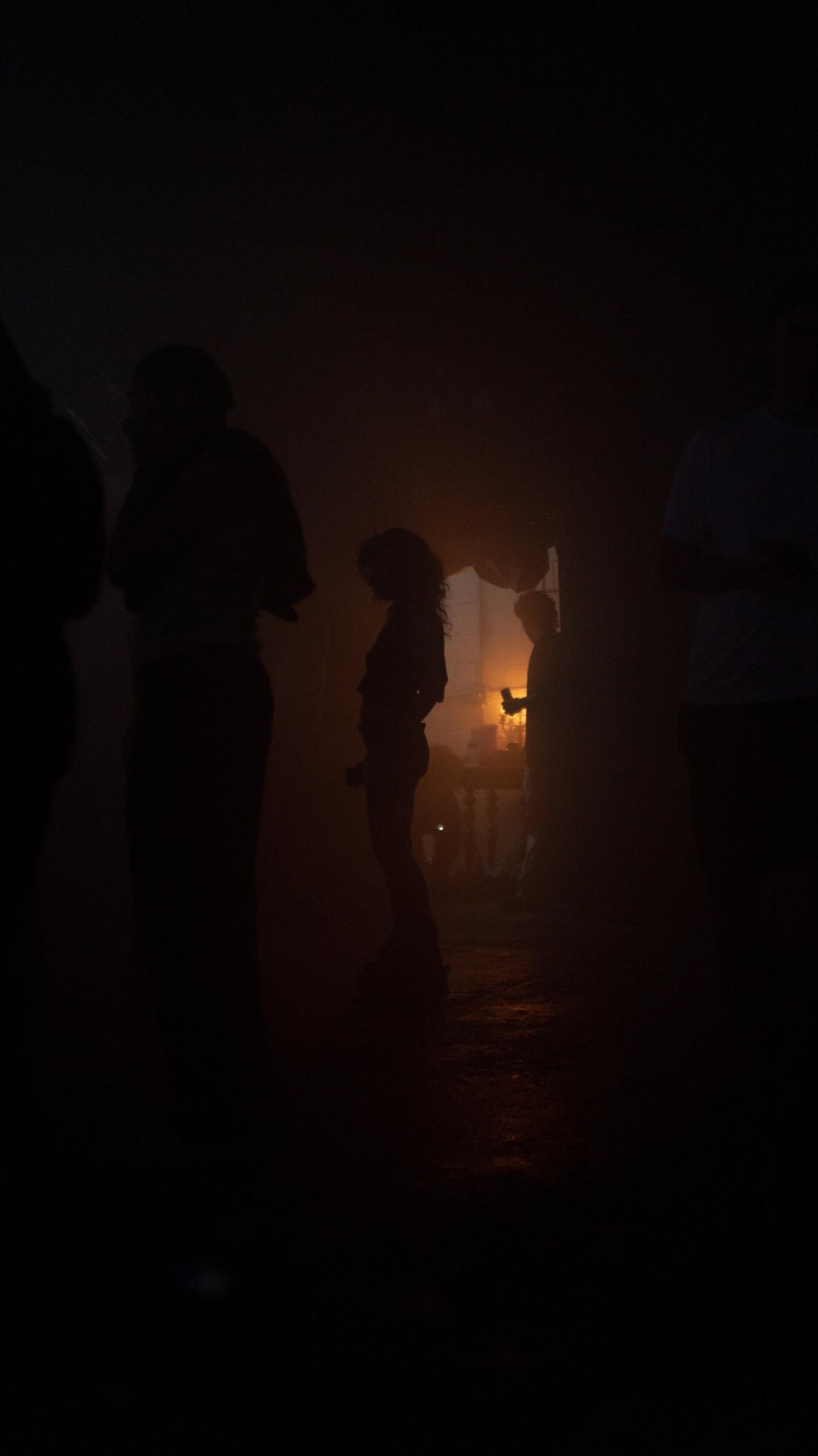 Figures in faint amber haze