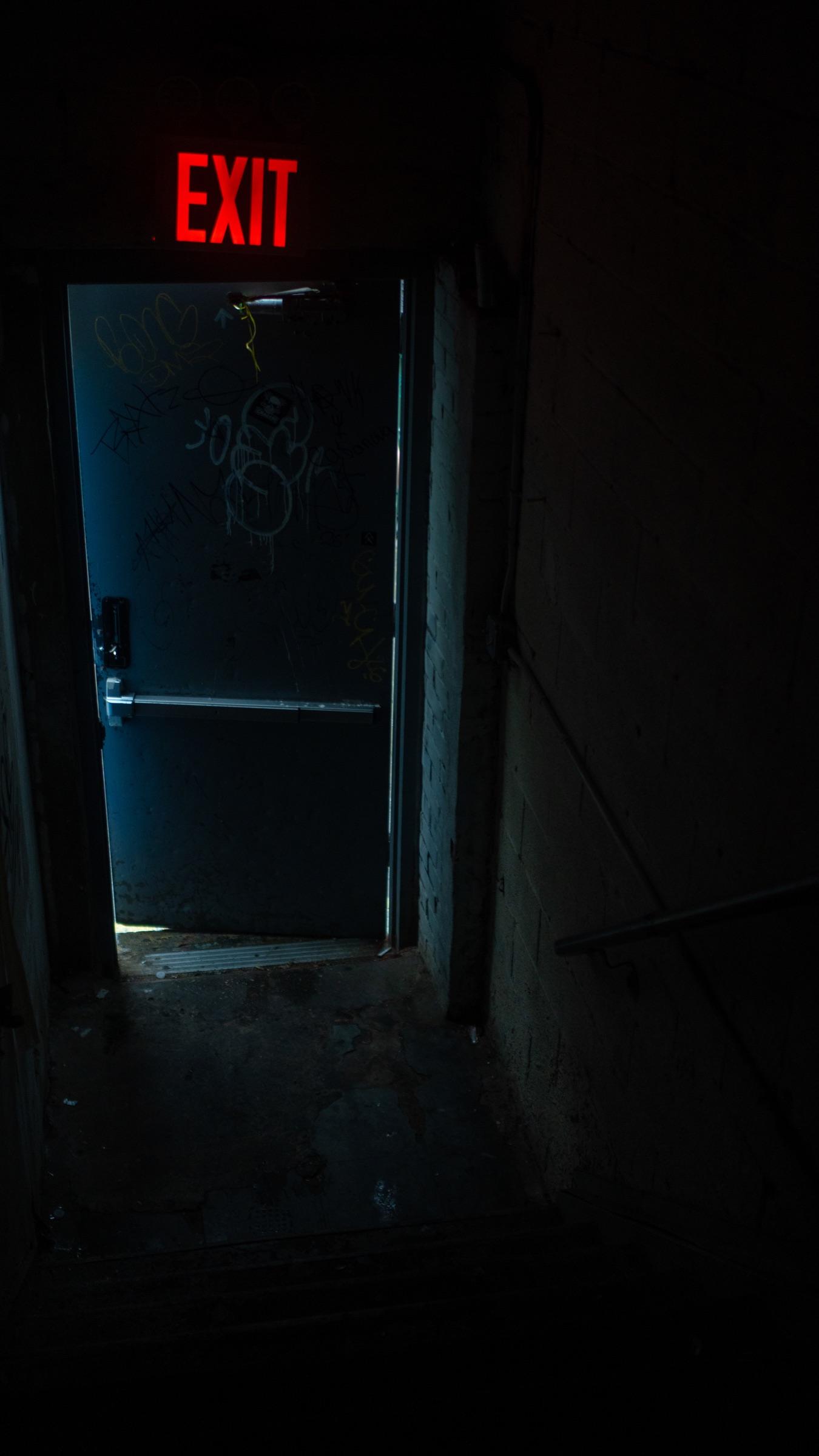 Dark doorway under a red exit sign