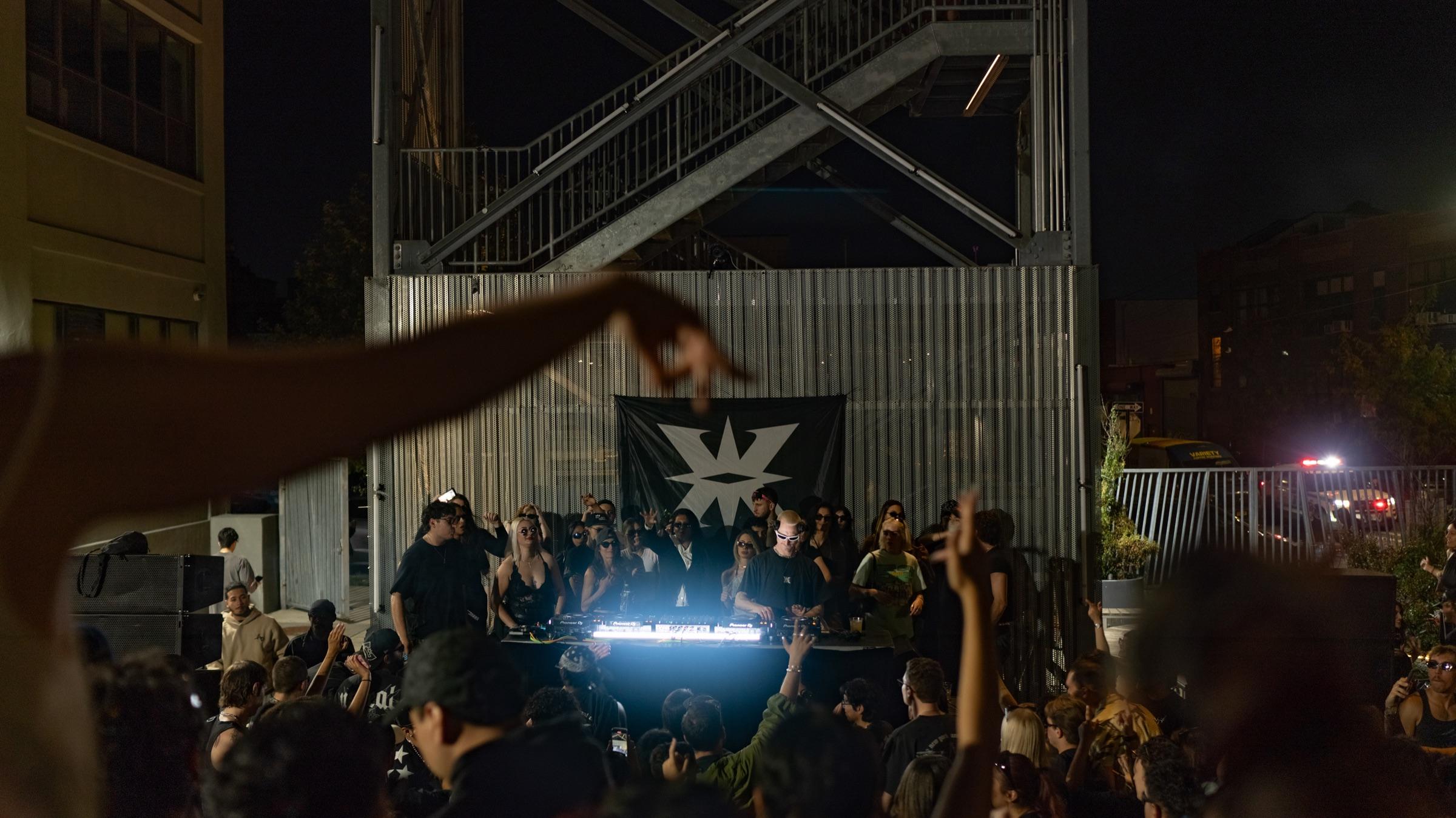 Courtyard with fire escape above a packed crowd