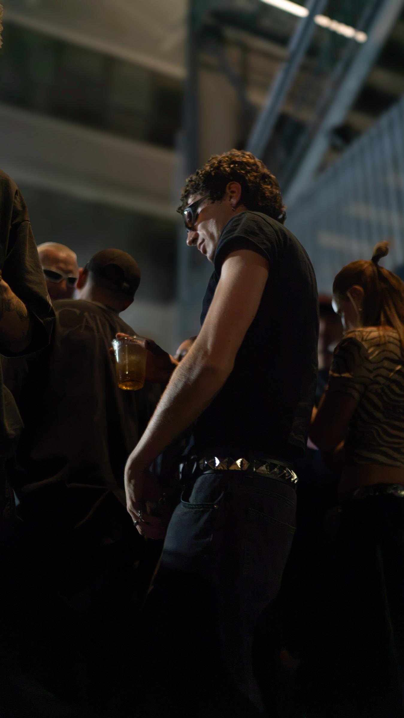 Dancer in a sleeveless top moving in the crowd
