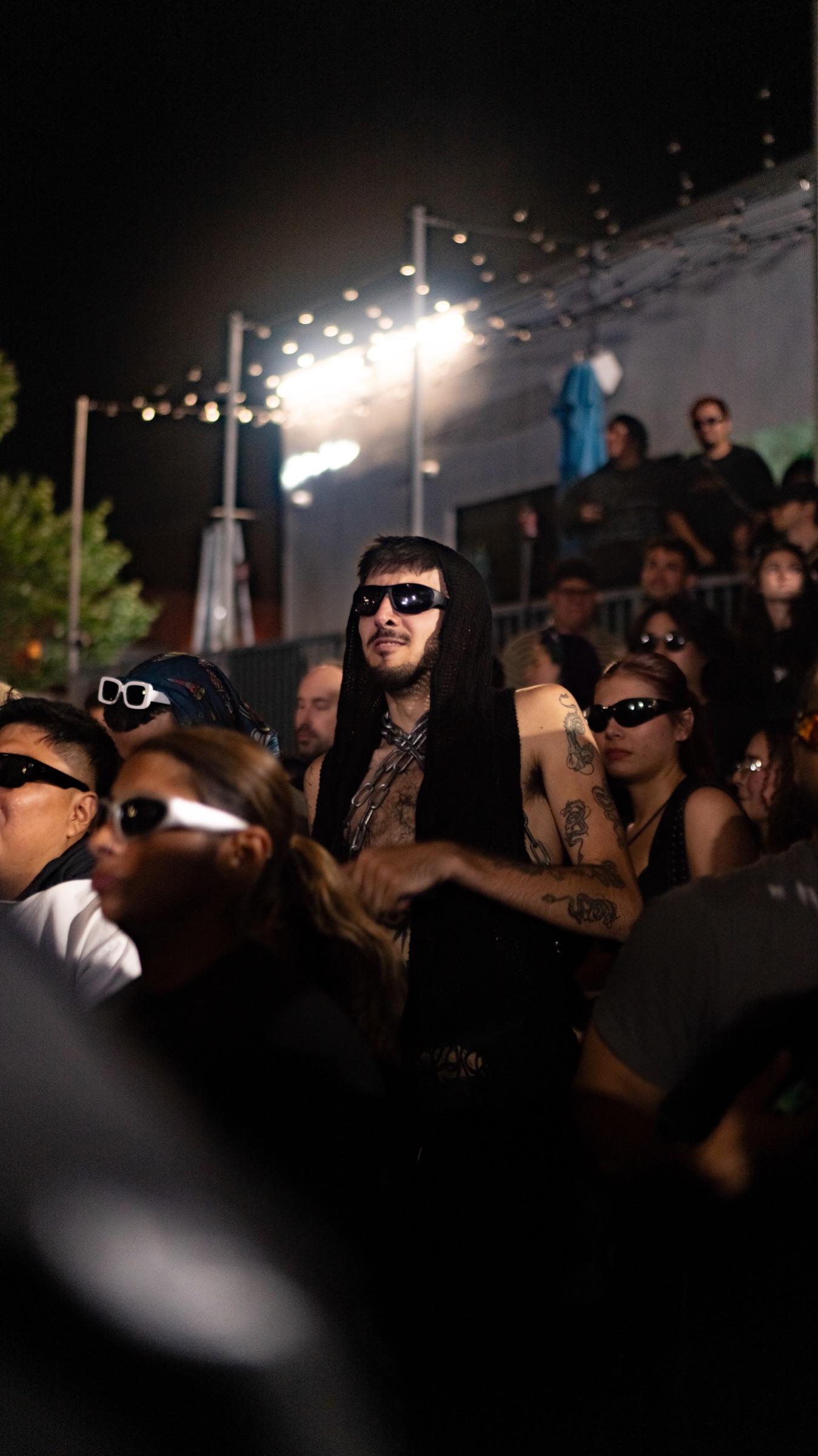 Dancers in sunglasses under stage lights