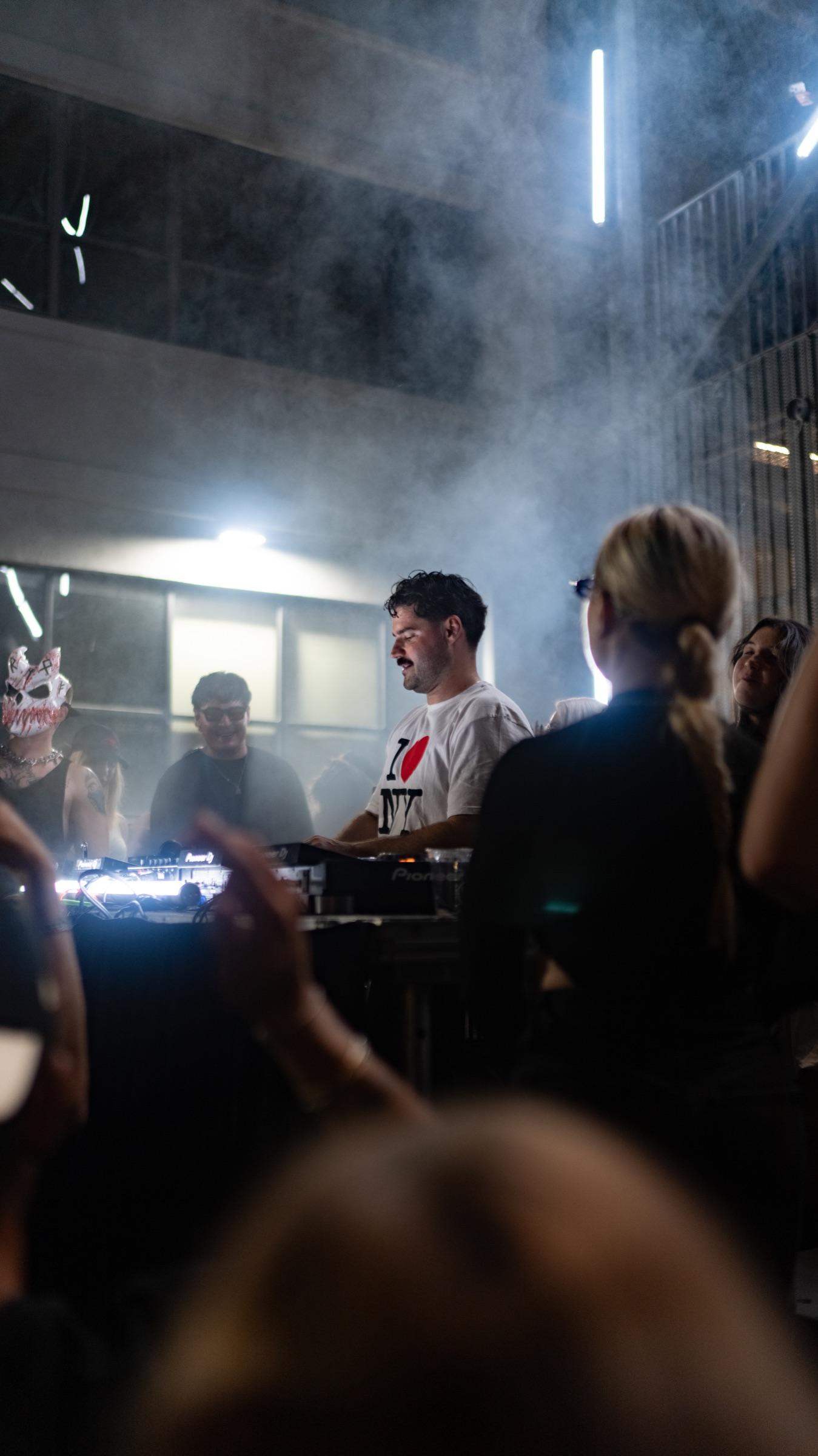 Smoke over the booth with dancers in the foreground