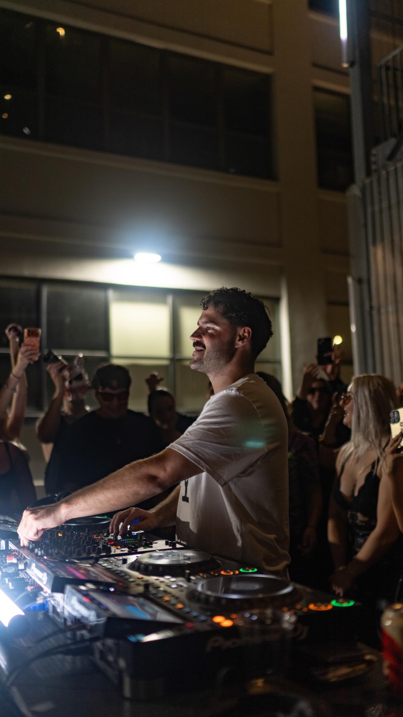 DJ mixing in front of the building