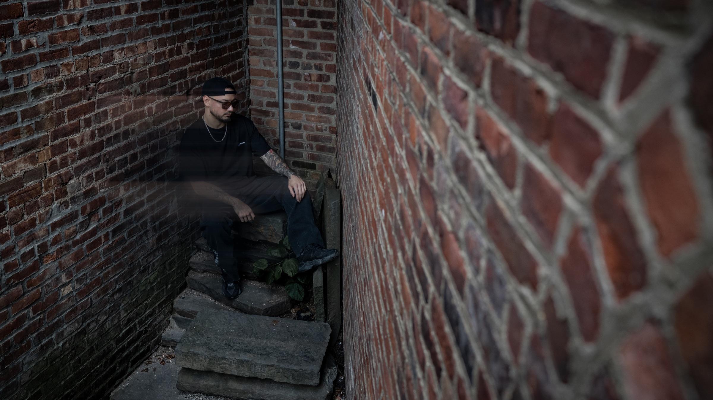Medina on alley steps, brick wall in the foreground