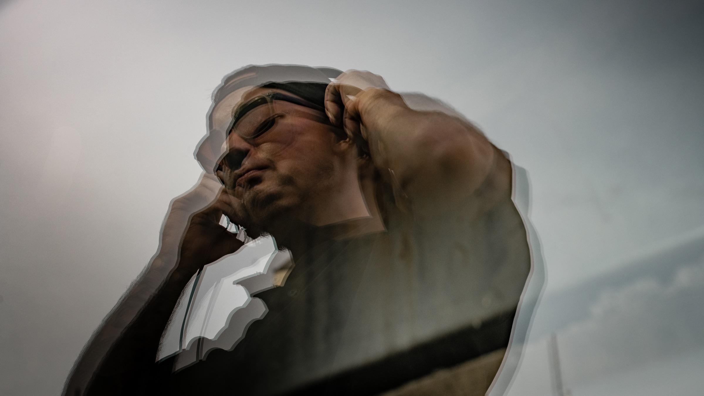 Wide double exposure of Medina, hand at the temple