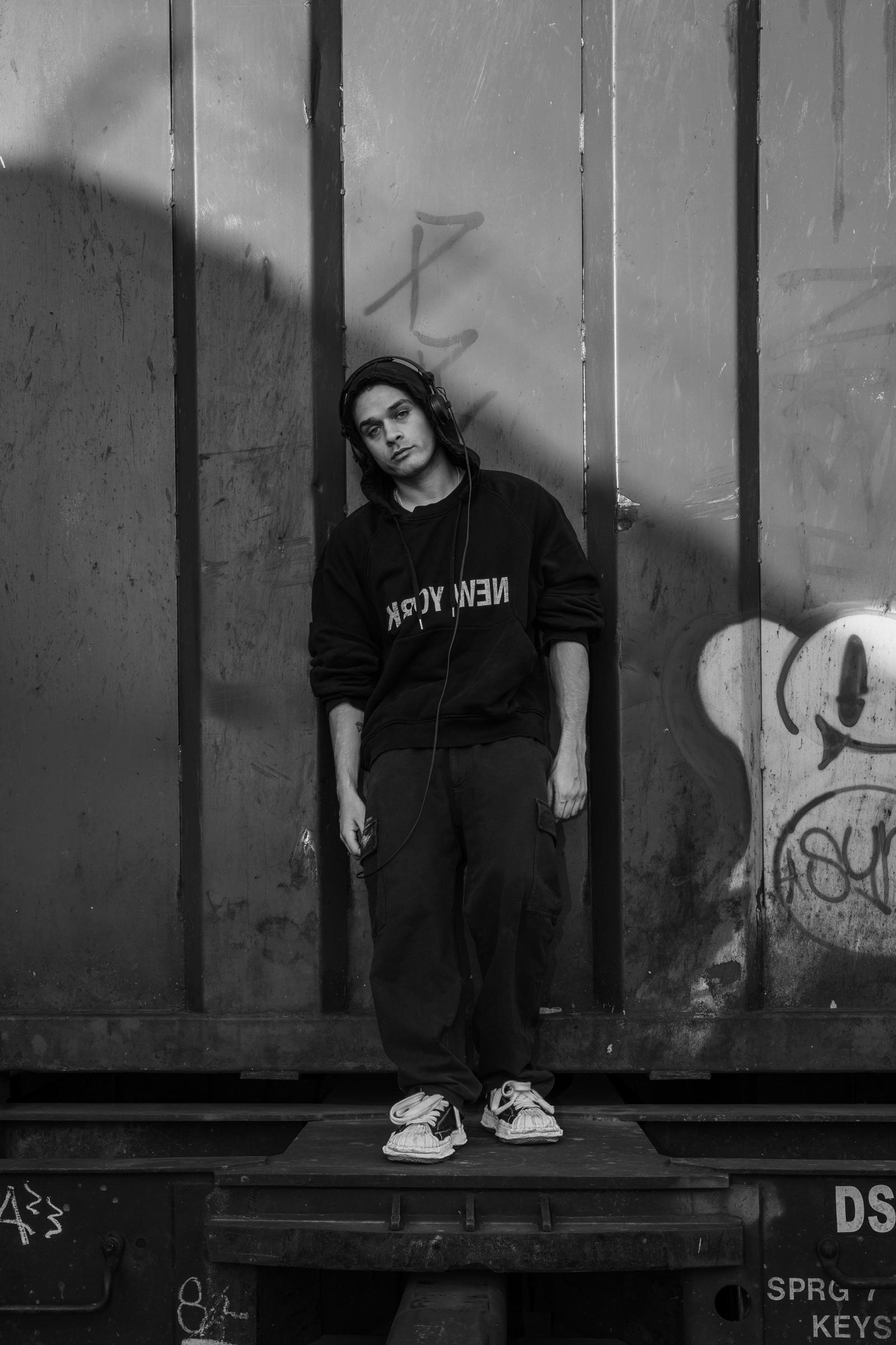 Black-and-white: artist standing on a freight car platform