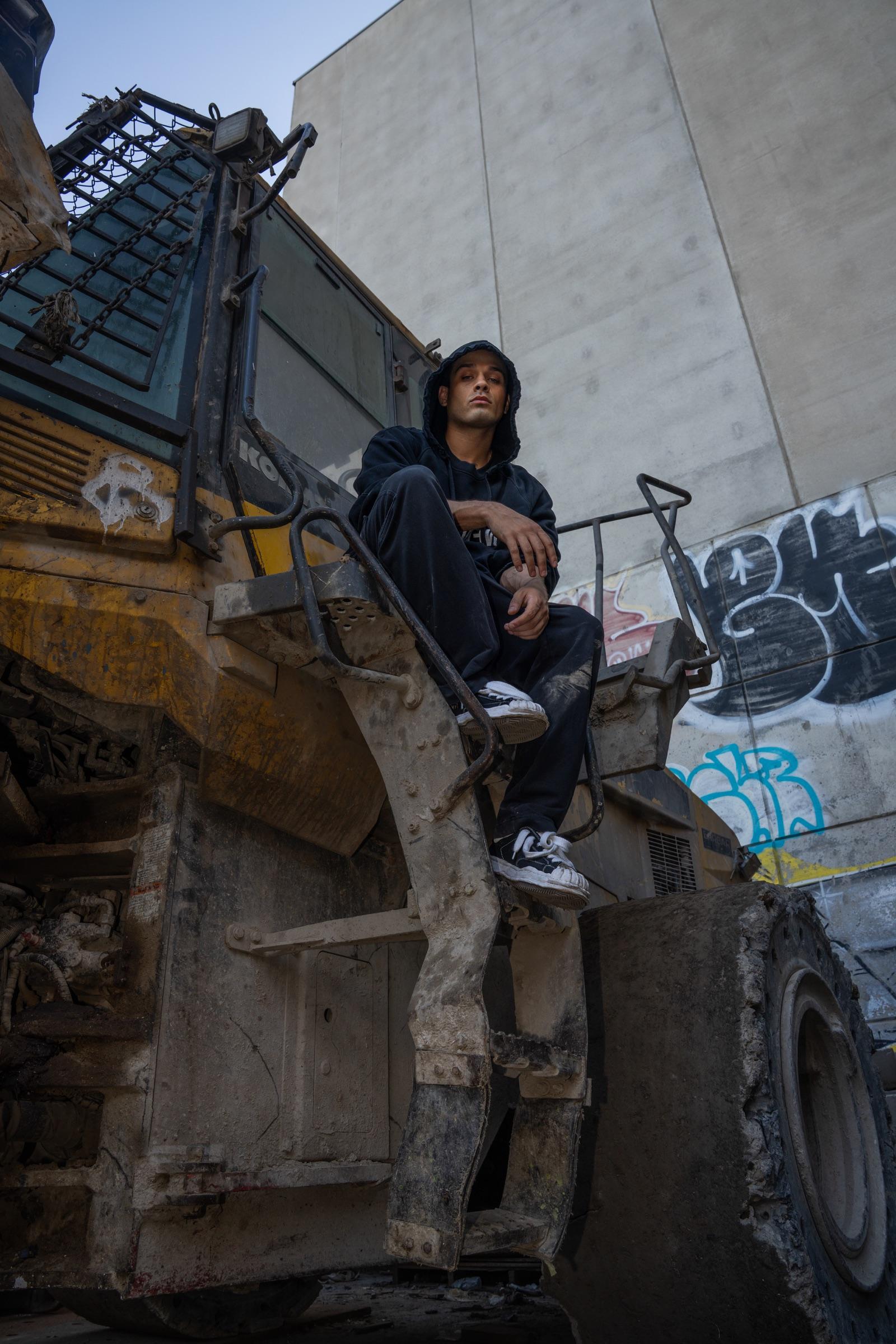 Artist seated on heavy machinery