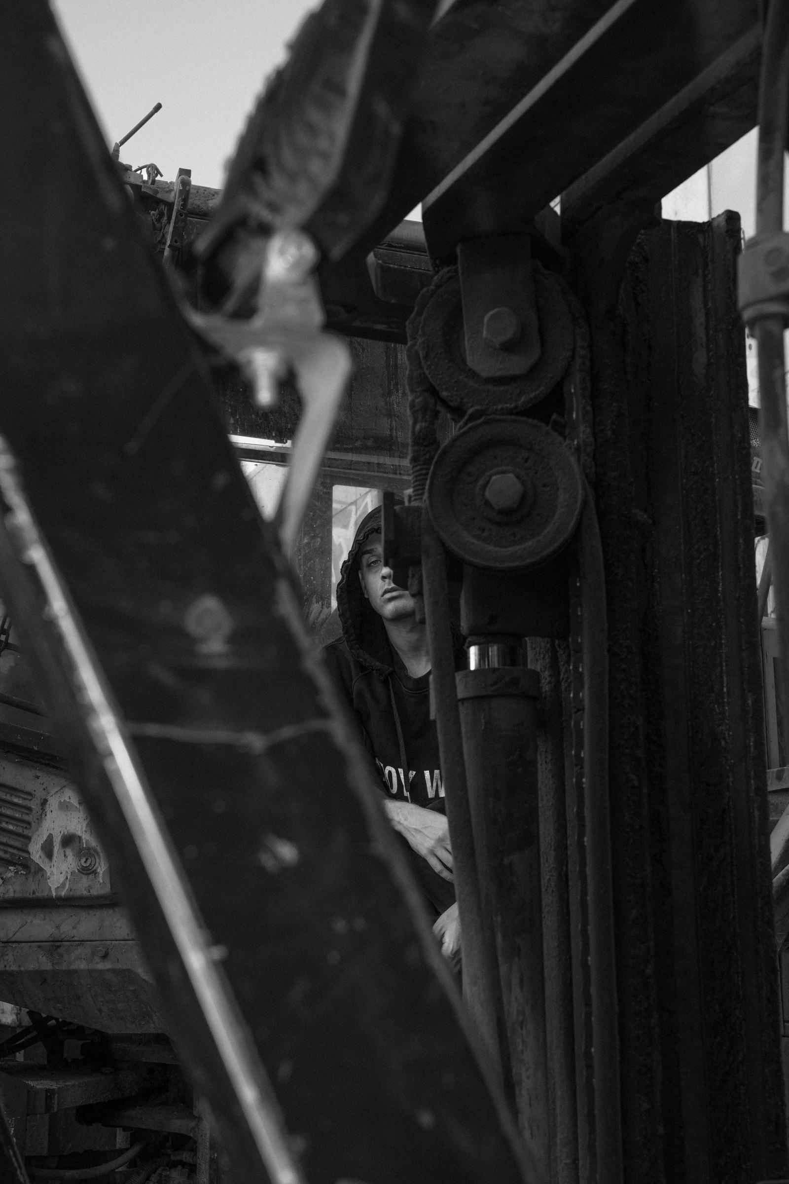 Black-and-white: artist framed by machinery
