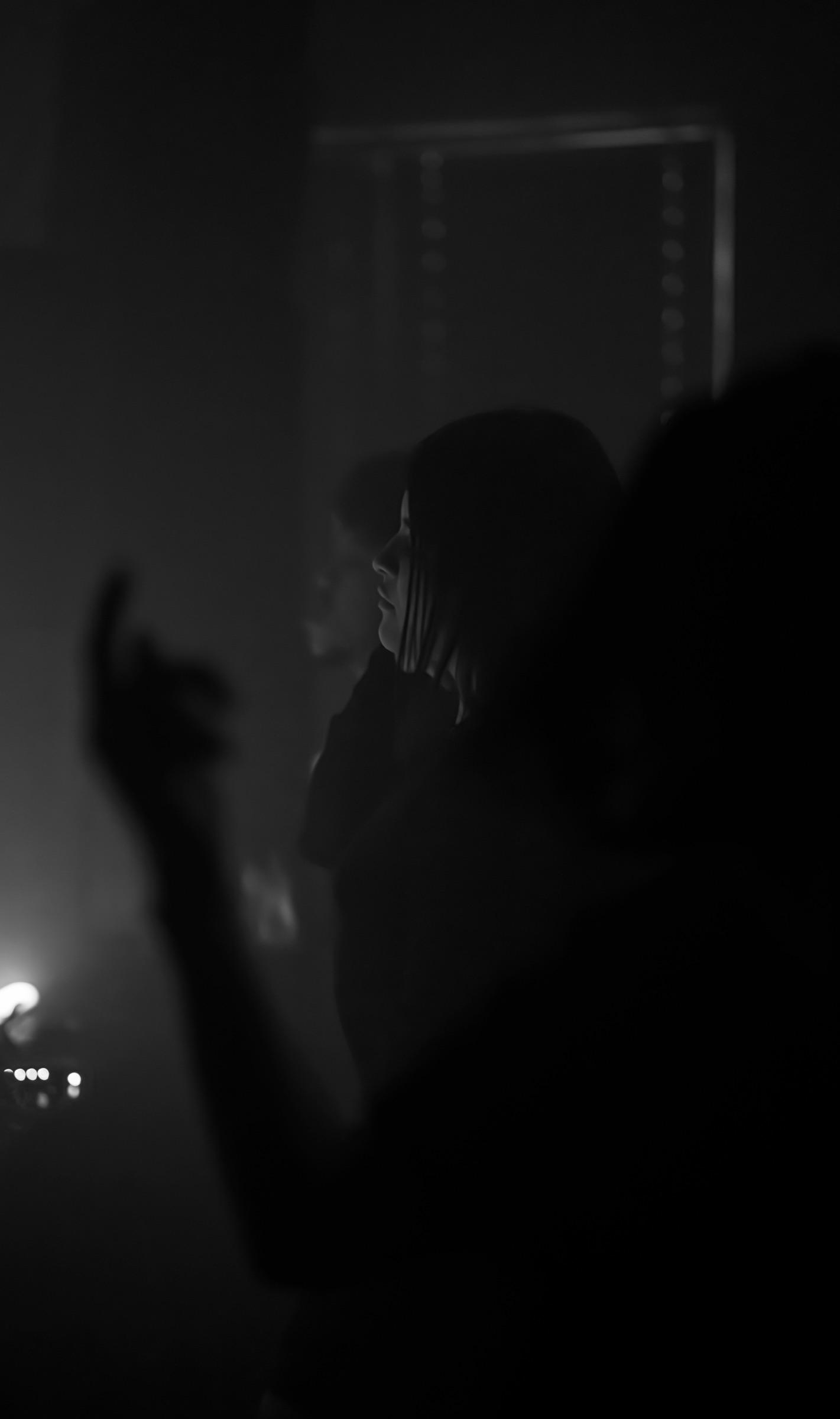 Dancer with a hand raised in smoke