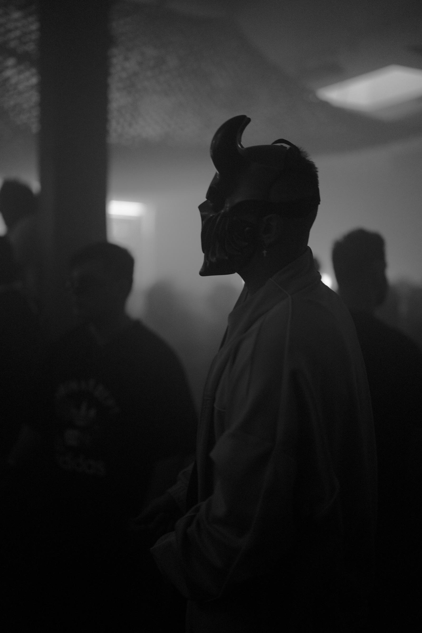 Dancer in a horned mask in the haze