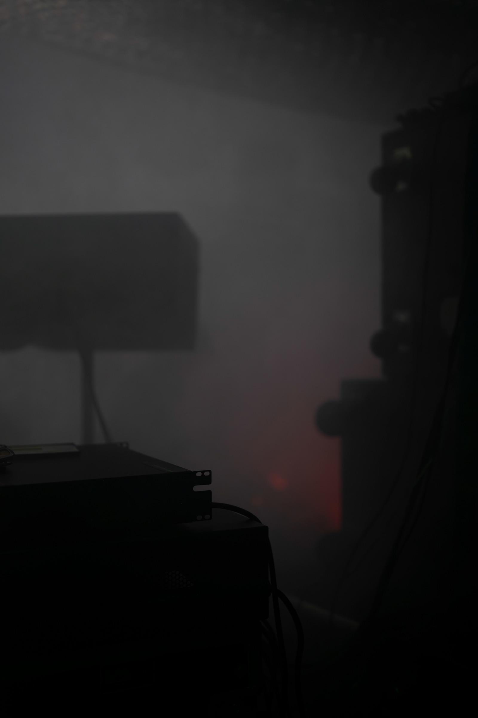 Speaker and figures in grey haze